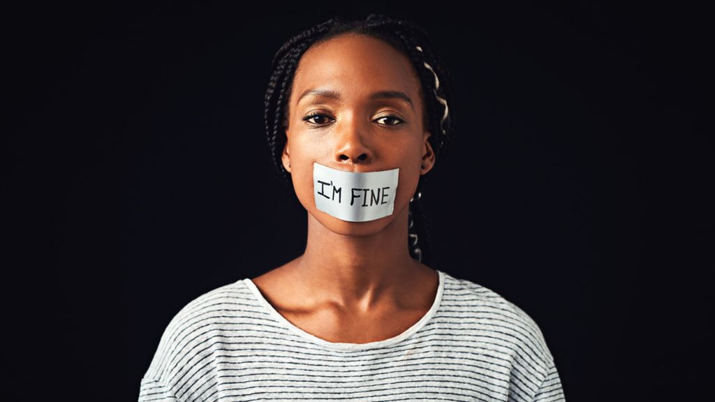 Woman with "I'm fine" sticker on her mouth