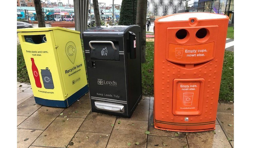 Yellow and orange recycling bins