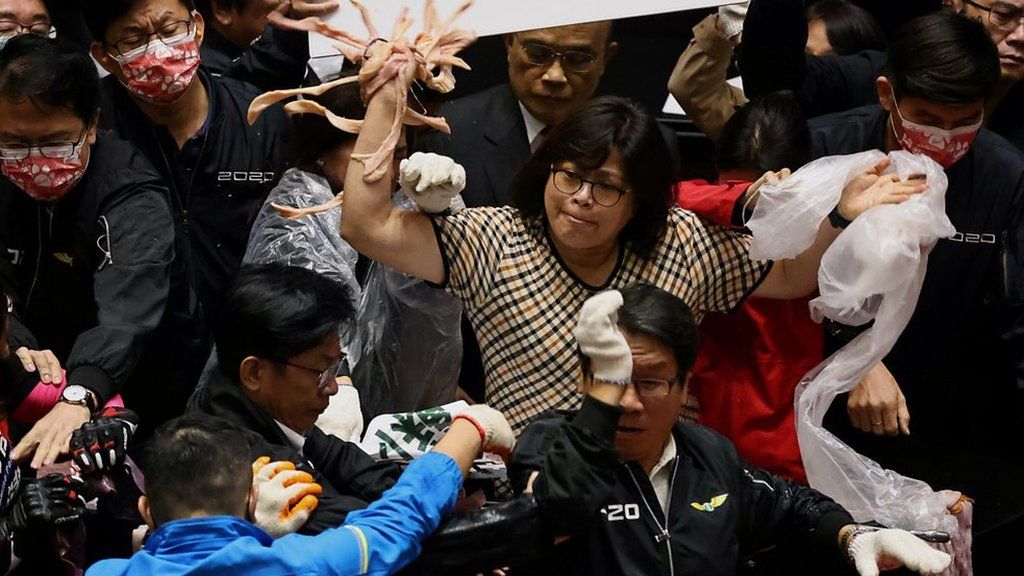 Taiwan lawmakers throw pork intestines at each other during a scuffle in the parliament in Taipei, Taiwan