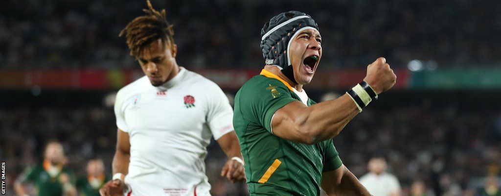 South Africa's Cheslin Kolbe celebrates as England's Anthony Watson looks down