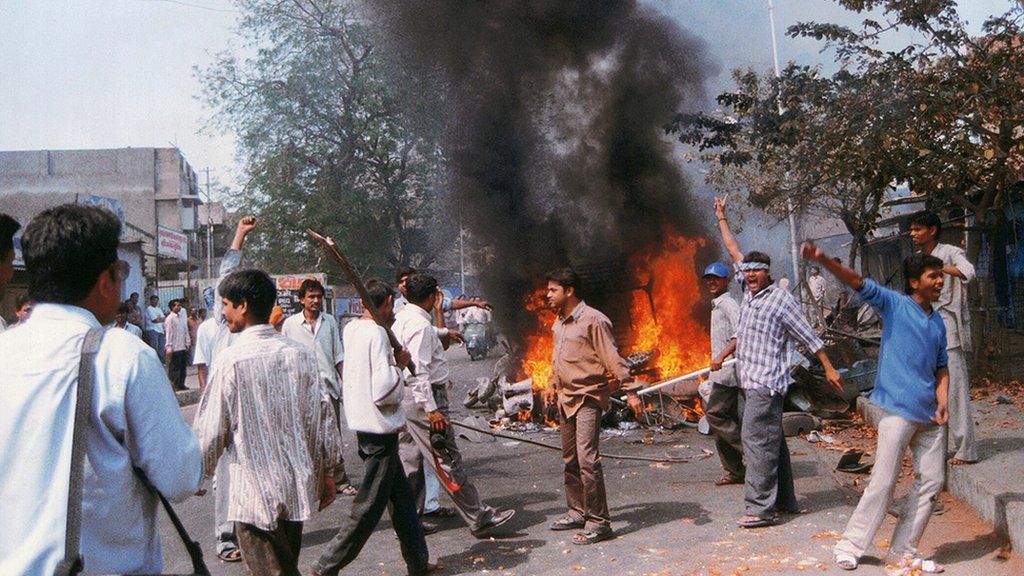 People riot in Godhra, Gujarat, India, 2002