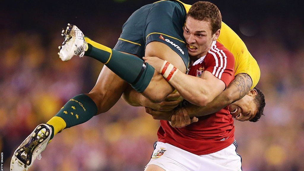 George North of the Lions lifts Israel Folau of Wallabies while carrying the ball