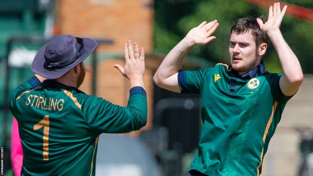 Josh Little is about to high five with Ireland skipper Paul Stirling after taking one of his six wickets