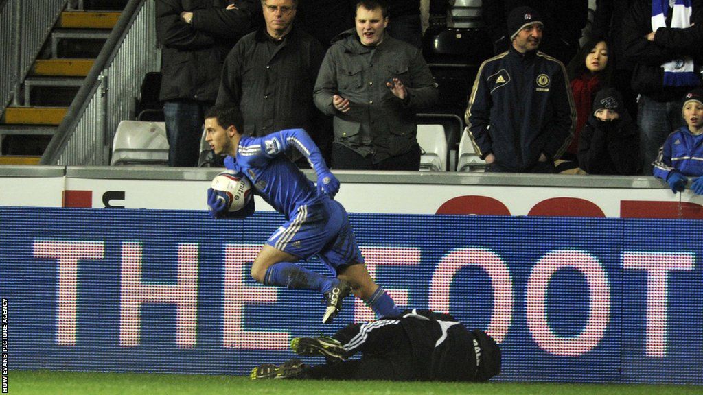 Eden Hazard runs away with the ball after tangling with ball boy Charlie Morgan