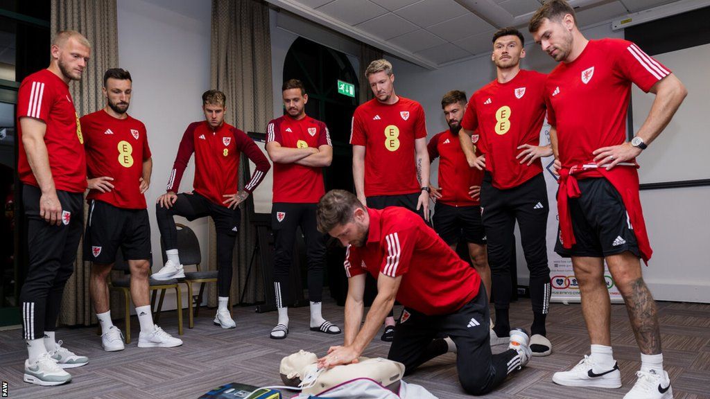 Wales players practicing CPR
