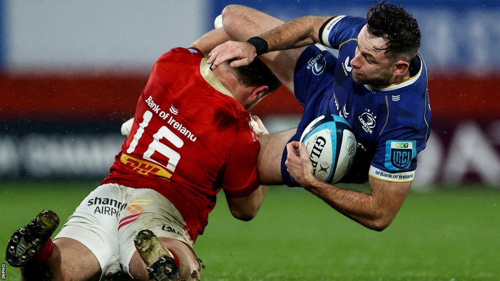 Munster replacement hooker Eoghan Clarke tackles Leinster's Hugo Keenan