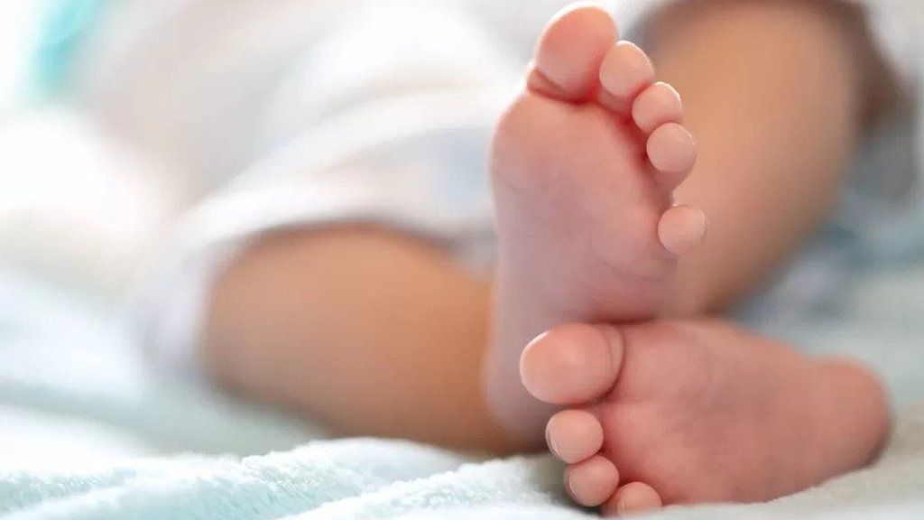 The feet of a new born child