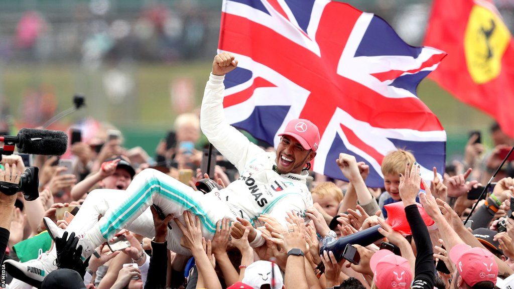 Lewis Hamilton is carried along by the crowd at Silverstone after winning the British Grand Prix in 2019
