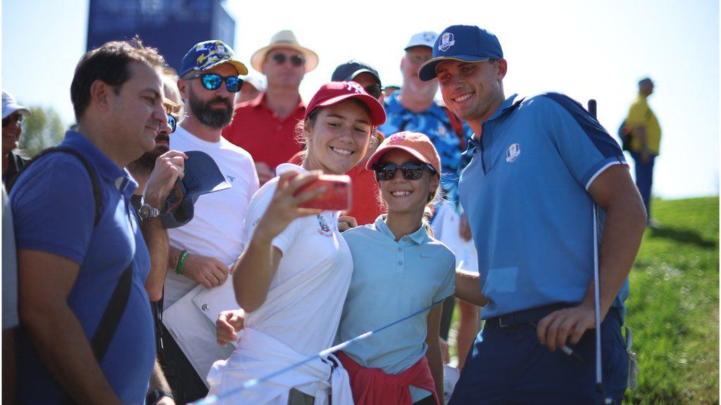 Ludvig Aberg (right) poses for photos with fans