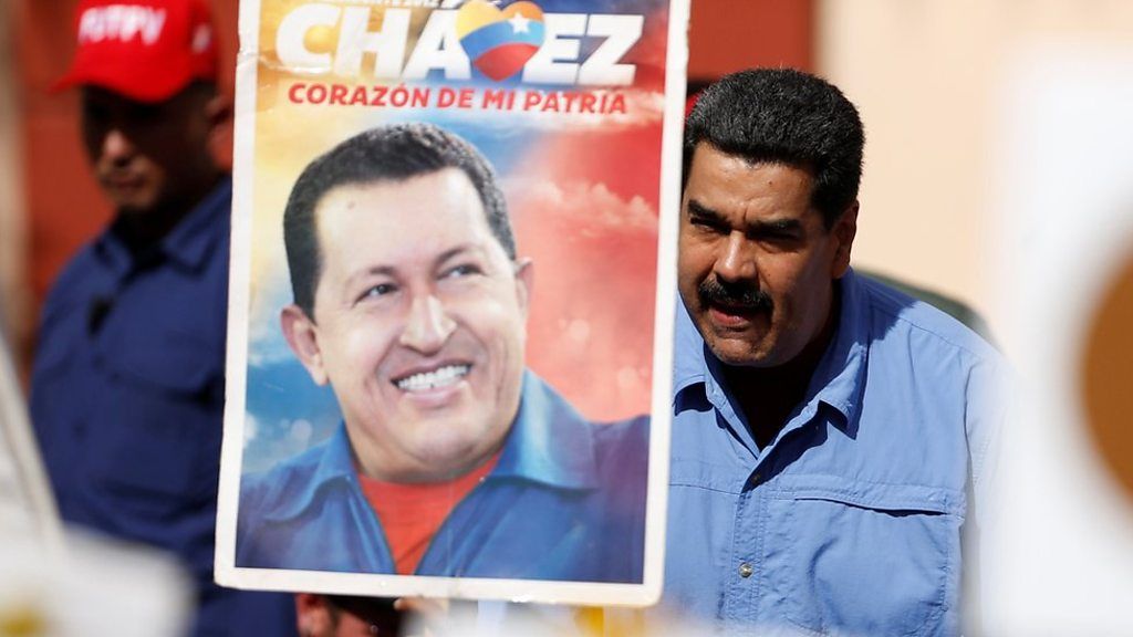 President Maduro and a placard with an image of Hugo Chavez