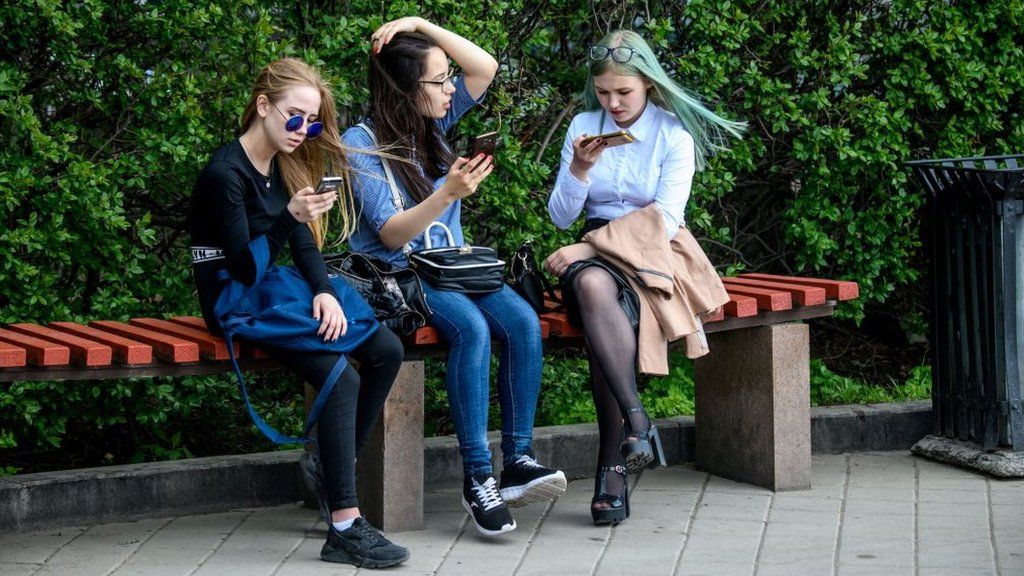 Young people looking at their phones
