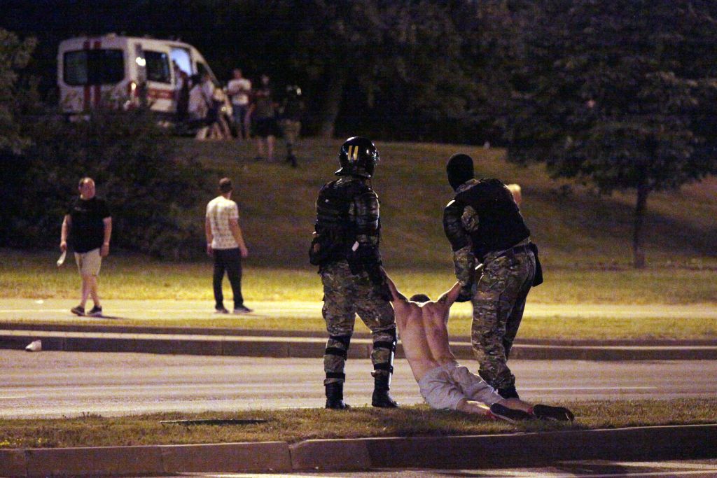 Police arrest a demonstrator in Minsk on 9 August
