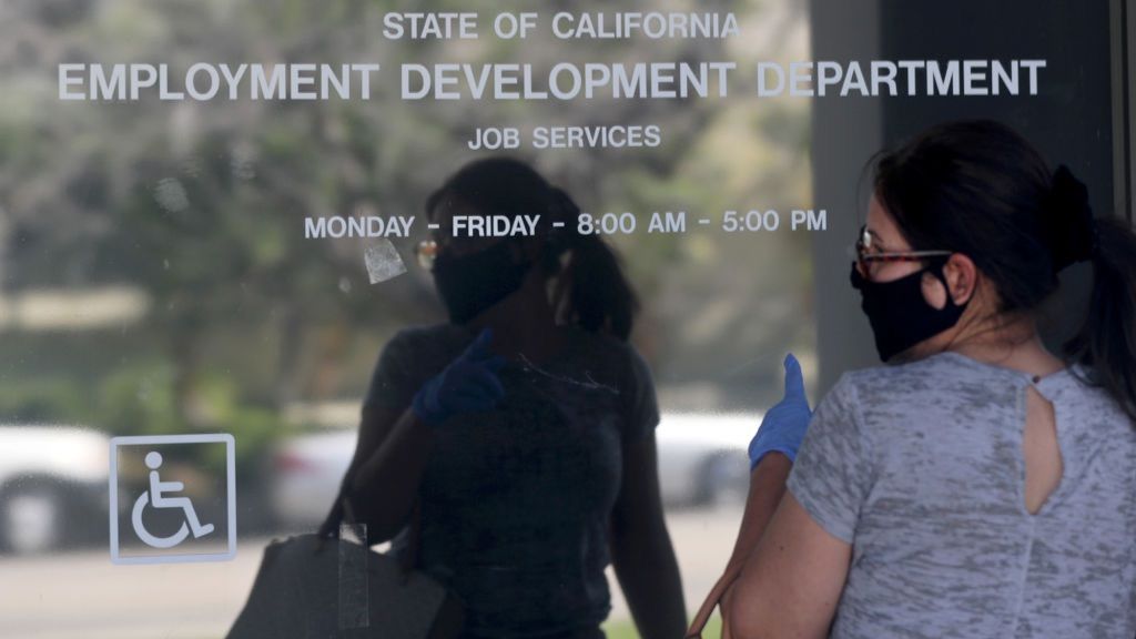Woman outside closed California State Employment Development Department office due to coronavirus.