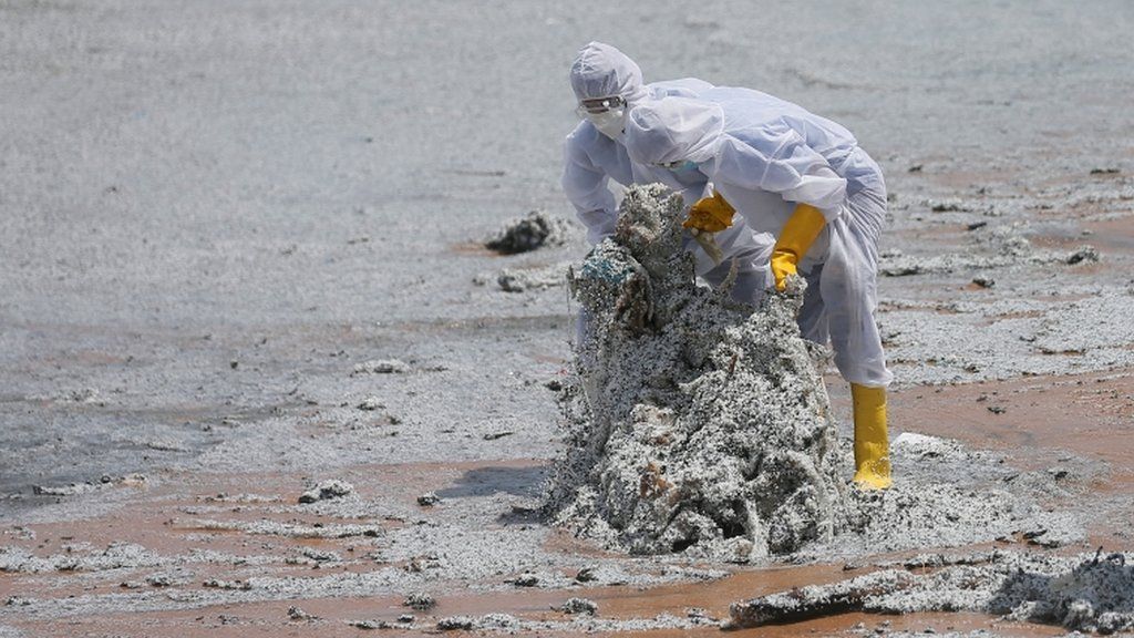 Sri Lankan navy members remove debris washed off to a beach from the MV X-Press Pearl container ship which caught fire off the Colombo Harbour, on a beach in Ja-Ela, Sri Lanka 27 May 2021.