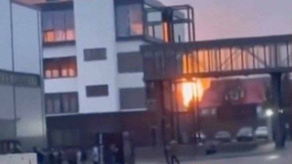 Footage from Ukraine as Russia attacks shows explosions, a fireball at an airport and a helicopter under fire.