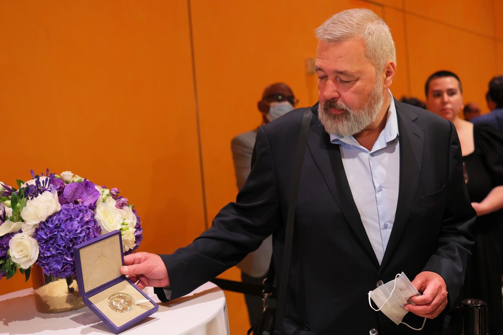 Dmitry Muratov poses with his 2021 Nobel Peace Prize at The Times Center on June 20, 2022 in New York City