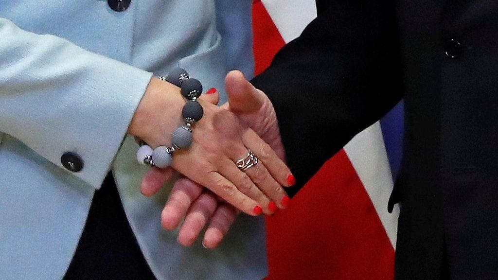 Handshake between Theresa May and Jean-Claude Juncker