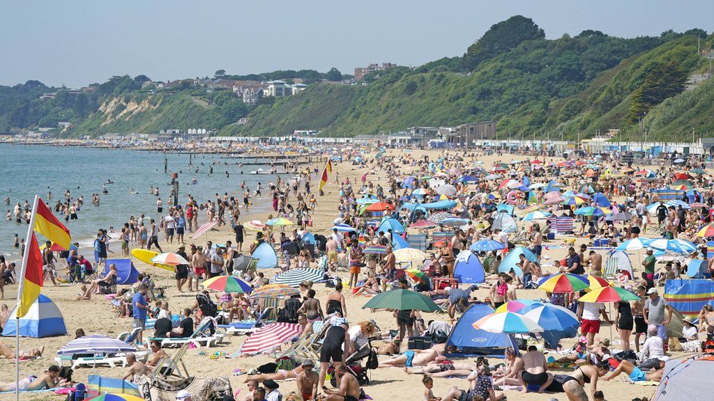 People lying on Bournemouth beach