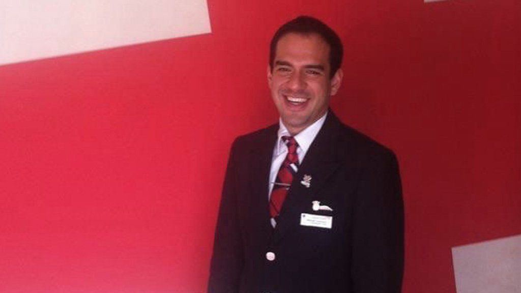 Manuel in his flight attendant uniform