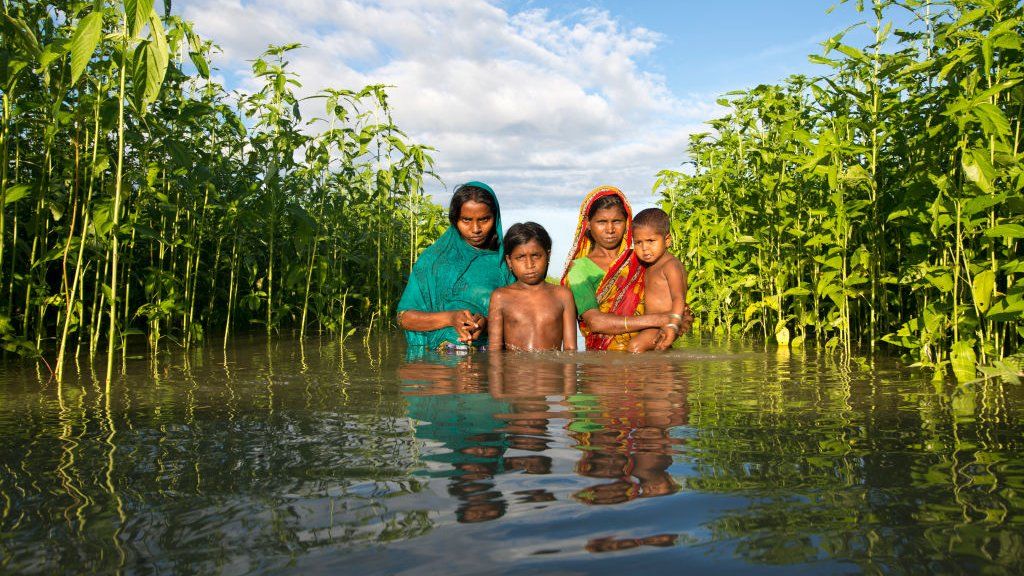 Family in floodwater in Bangladesh