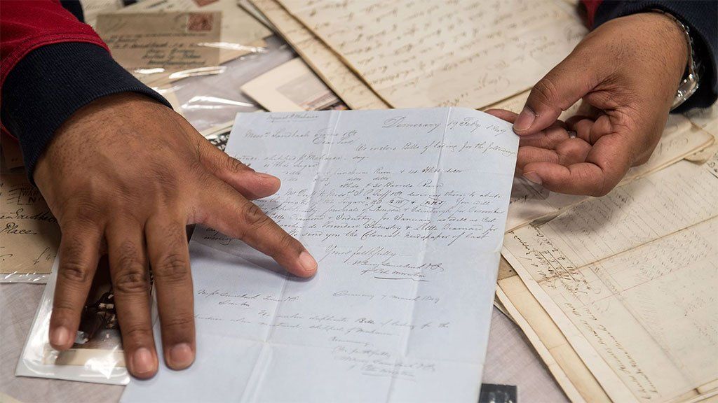 Malik Al Nasir looks through letters about the slave trade