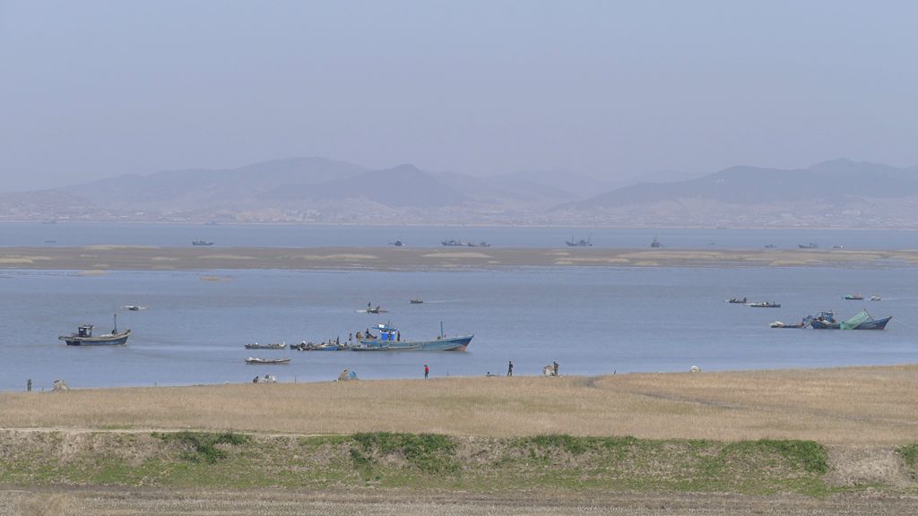 Fishing fleet and offshore mudbank in the estuary of the Chong Chon River, North Korea