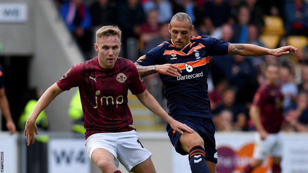 Oscar Threlkeld tussles with Dan Pybus during a National League fixture between York City and Oldham Athletic at the LNER Community Stadium, York in August 2022