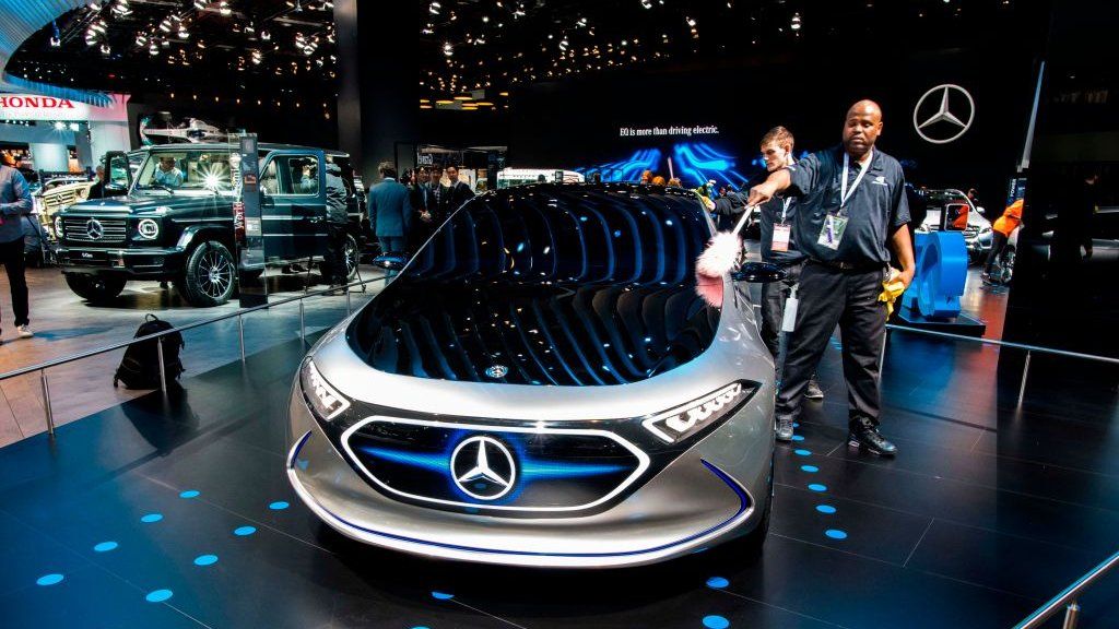 A man cleans the Mercedes-Benz concept EQA show car at the 2018 North American International Auto Show (NAIAS) in Detroit, Michigan, on January 15, 2018.