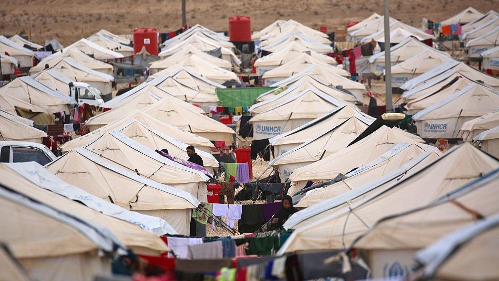 Iraqi refugees, who fled the Iraqi city of Mosul due to the fighting between government forces' and Islamic State (IS) group's jihadists, stand next to tents at the UN-run al-Hol refugee camp in Syria's Hasakeh province, on December 5, 2016.