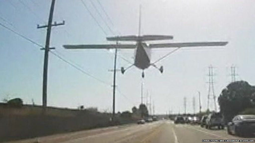 Plane flying over road in Huntington Beach, California