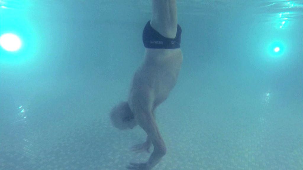 100 year old man handstands underwater