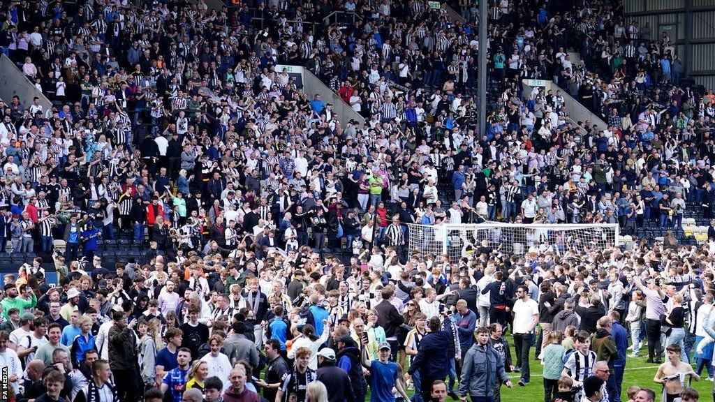 Notts County fans spill onto the Meadow Lane pitch after the Magpies beat Boreham Wood
