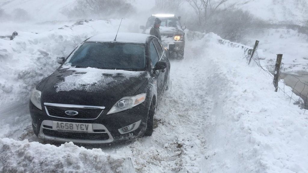 A vehicle covered in snow