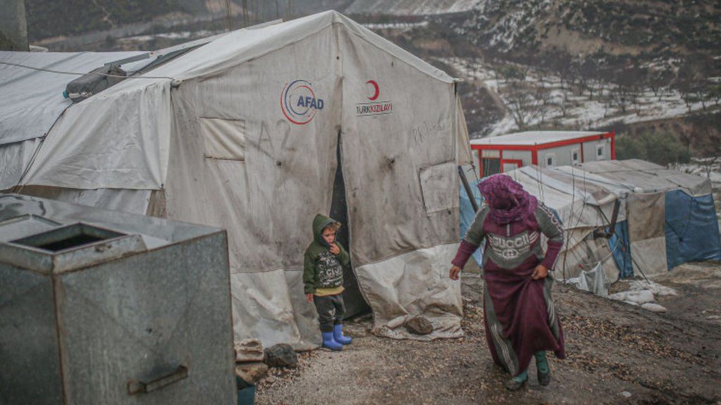 A woman and a child at a camp for displaced people in Idlib province, north-western Syria (26 January 2022)