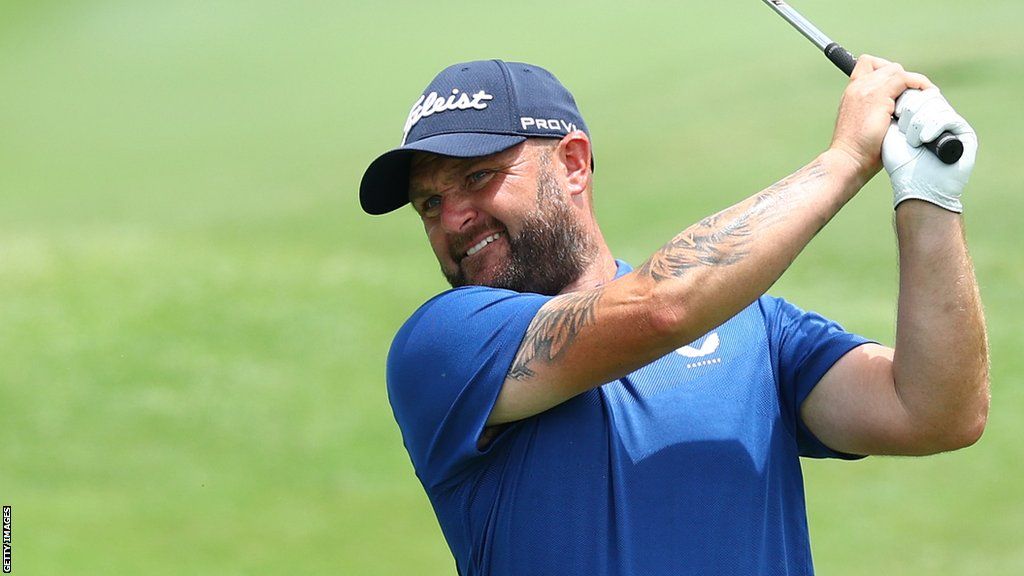 Andy Sullivan watches an approach shot at the Singapore Classic