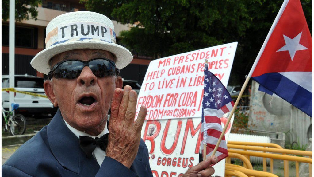 A pro-Trump supporter in 2017 with a sign supporting the president's action on Cuba