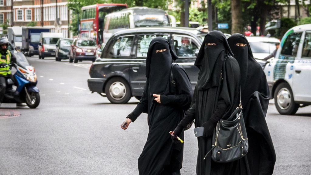 Muslim women cross a road in west London, File photo - May 2014