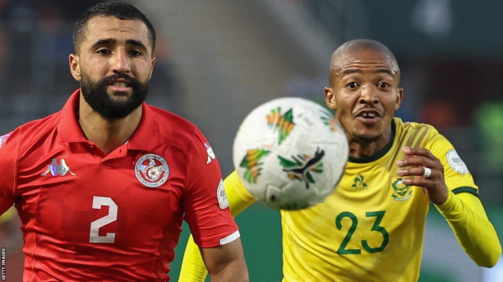 Ali Abdi and Thapelo Morena eye the ball during the 2023 Africa Cup of Nations Group E match between South Africa and Tunisia