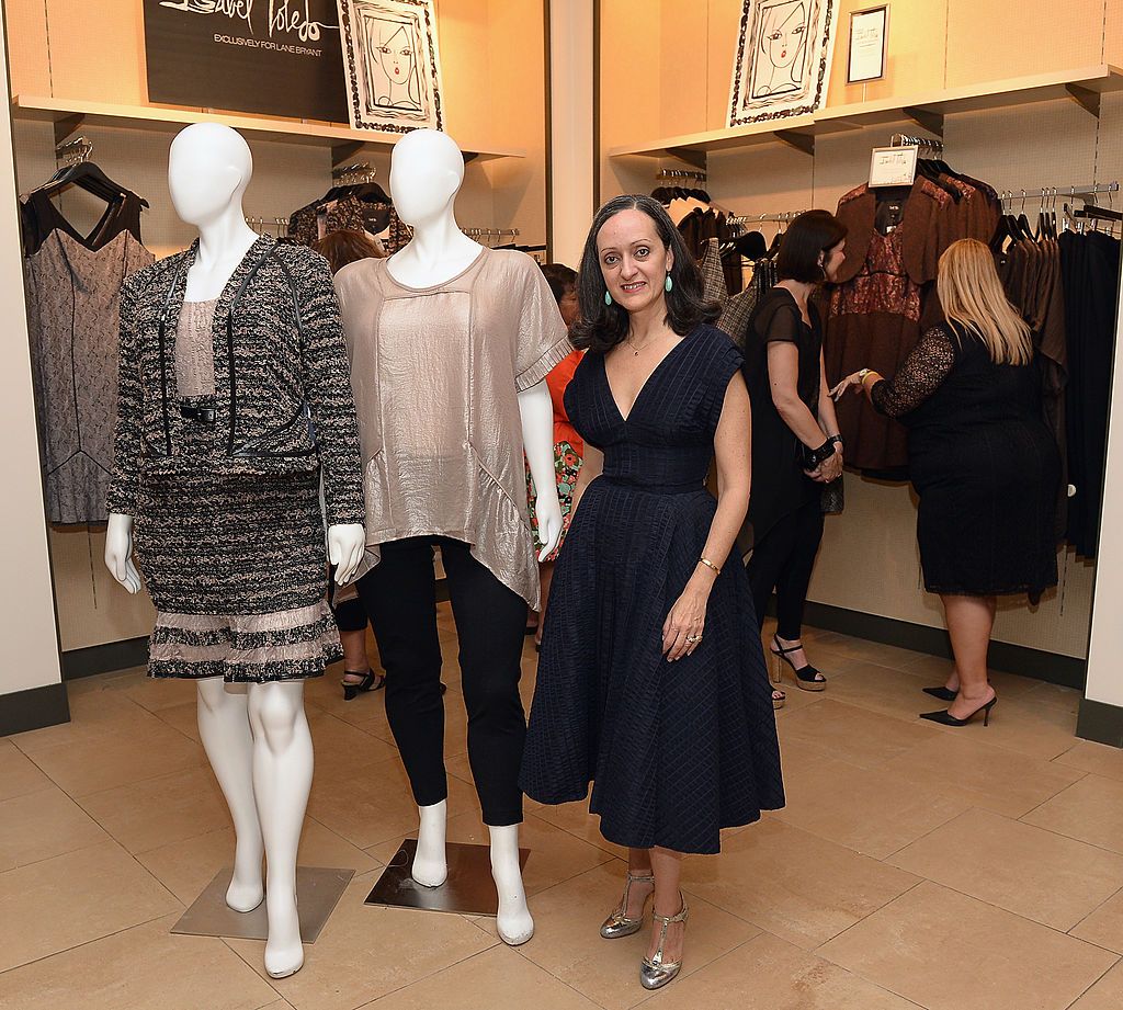 Isabel Toledo standing next to her plus size designs. displayed on mannequins, for Lane Byrant in 2014