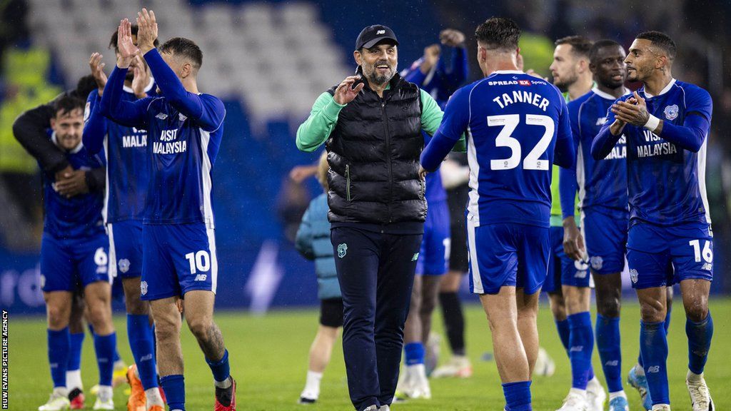 Cardiff boss Erol Bulut celebrates with his players after their win over Swansea