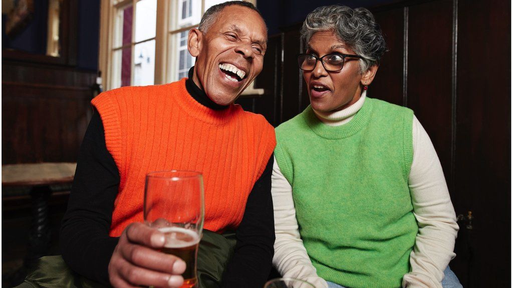 two people drinking beer stock imae