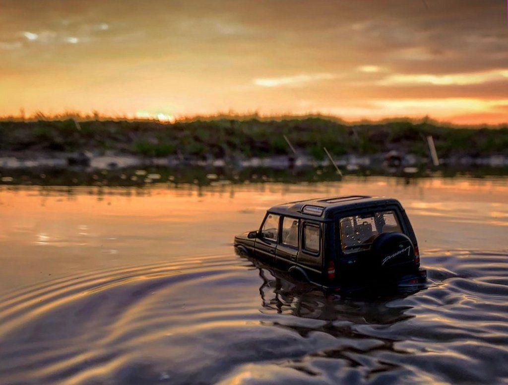 Model Land Rover drives through a river