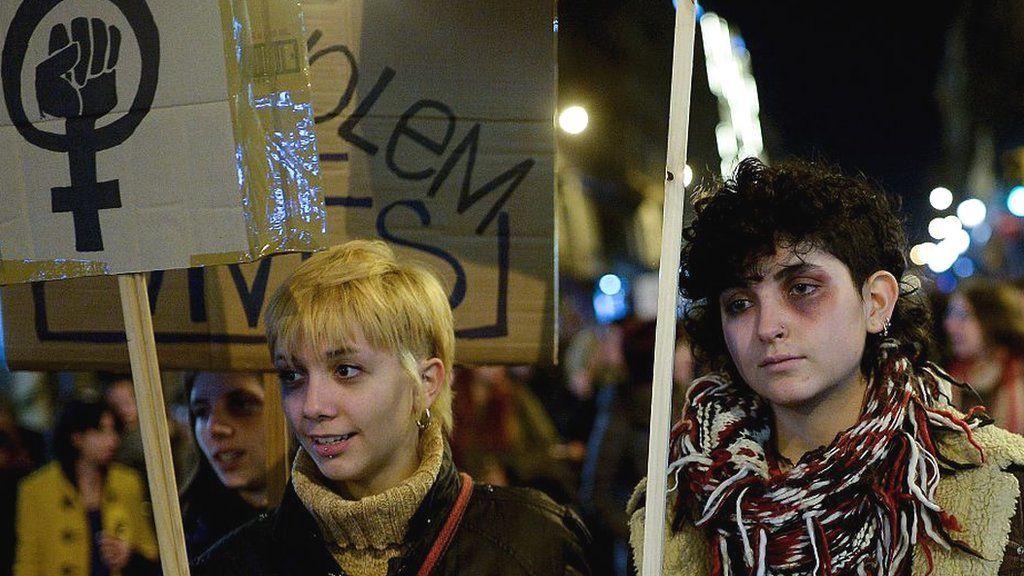 Women with artificial black eyes protest against domestic violence in Barcelona on 25 November 2015