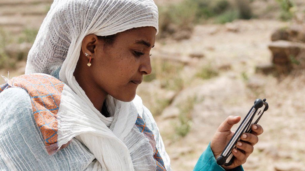 A woman using a mobile phone in Tigray region of Ethiopia