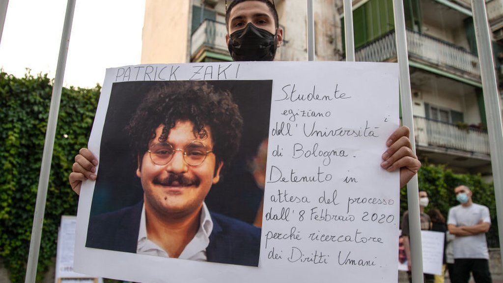 A man shows a photograph of Patrick Zaky during a demonstration in solidarity with human rights activists detained around the world on 16 June 2021 in Naples, Italy