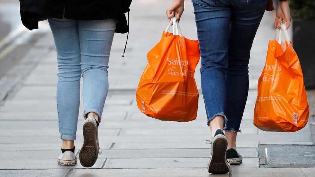 Shoppers carrying Sainsbury's bag