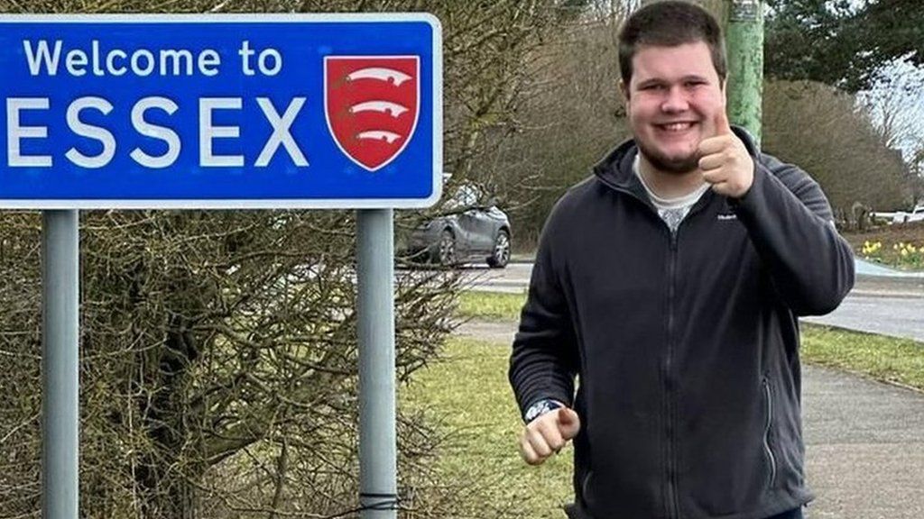 Kireon Wicks at one of the Welcome to Essex signs