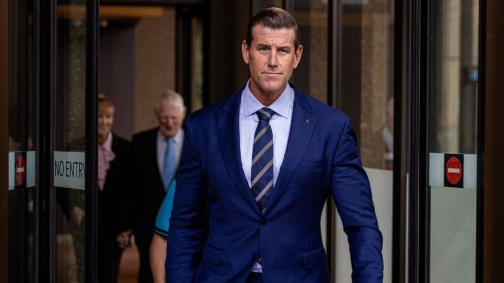 Roberts-Smith walks out of the Federal Court in Sydney in May 2025. In the background are his parents.