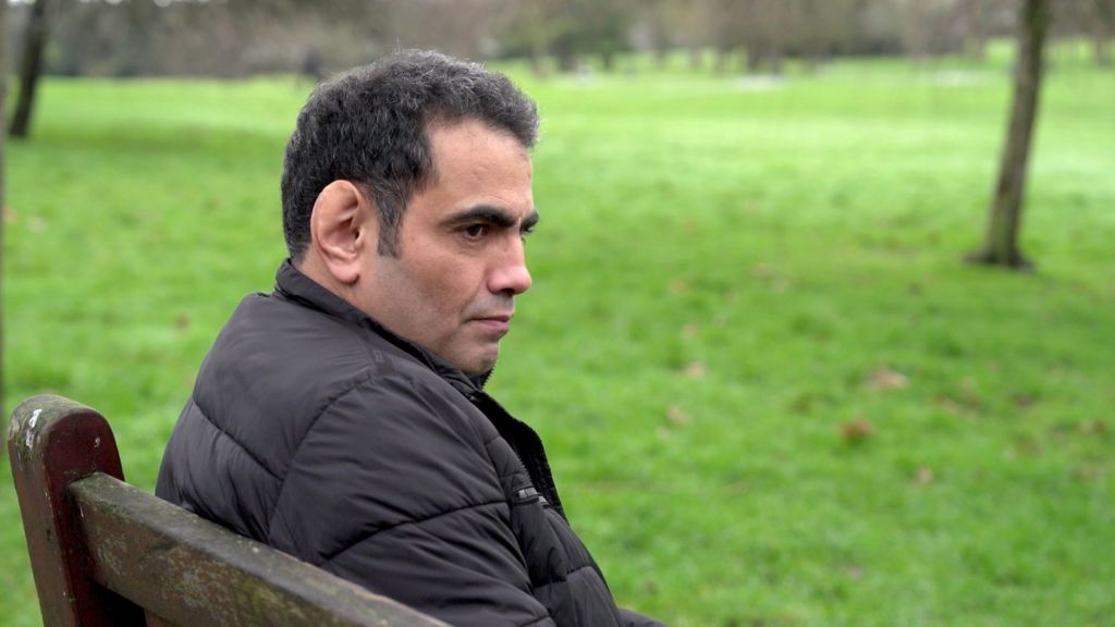 Ghanem al-Masarir in a park. 45 years old with black greying hair.