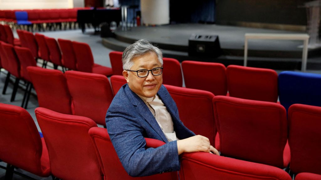 The head pastor of the Zion church in Beijing Jin Mingri poses for picures in the congregation hall of the unofficial Protestant "house" church in Beijing, China, 2018.